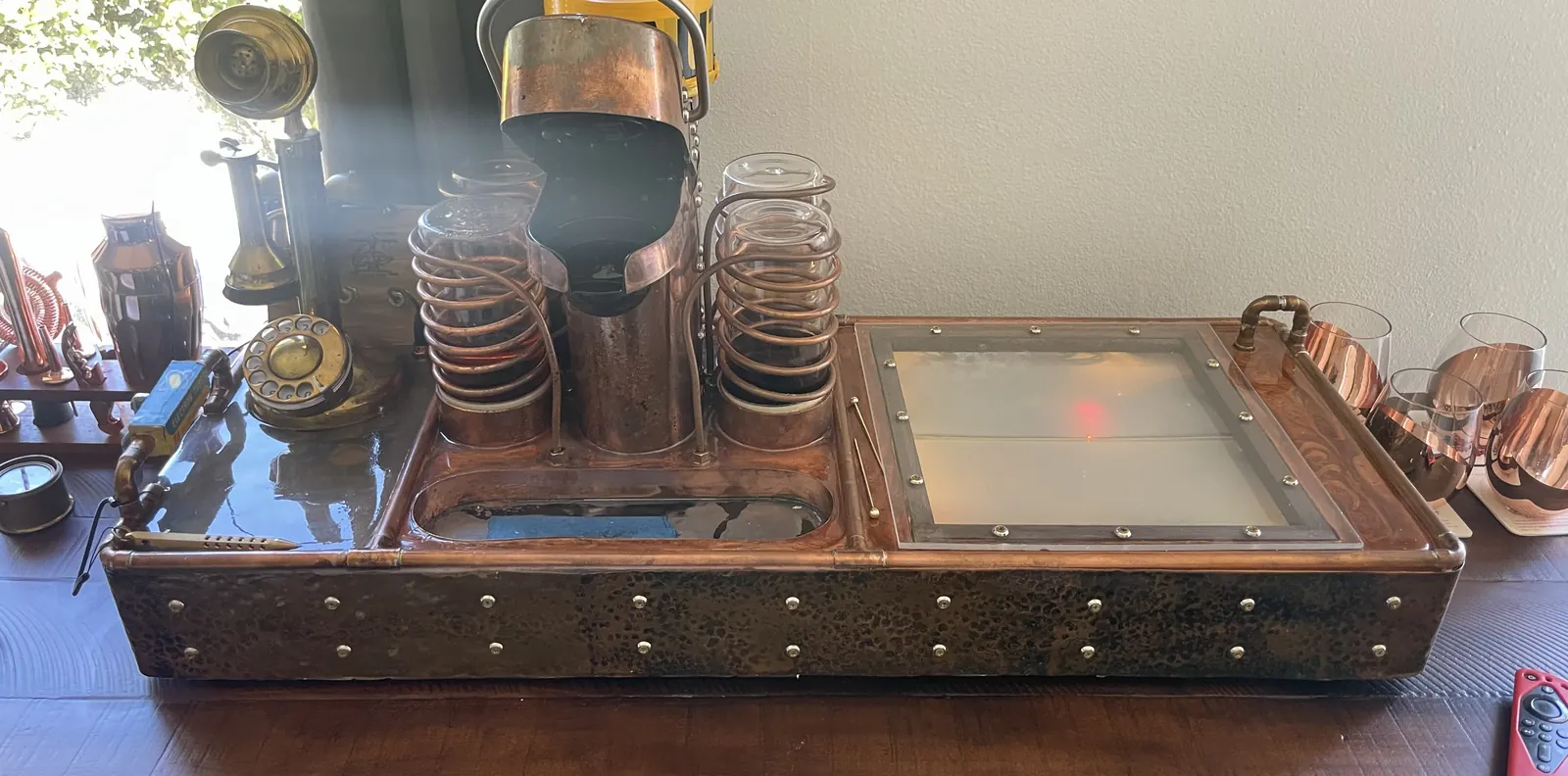 The full width of the machine on its cart: telephone at left, tubes and coils in the middle, tray at right