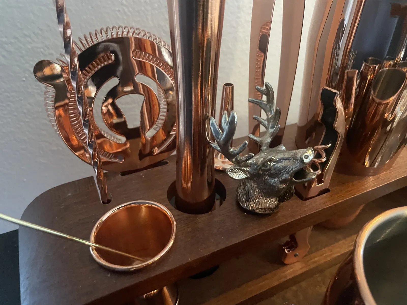 A collection of copper barware on a shelf