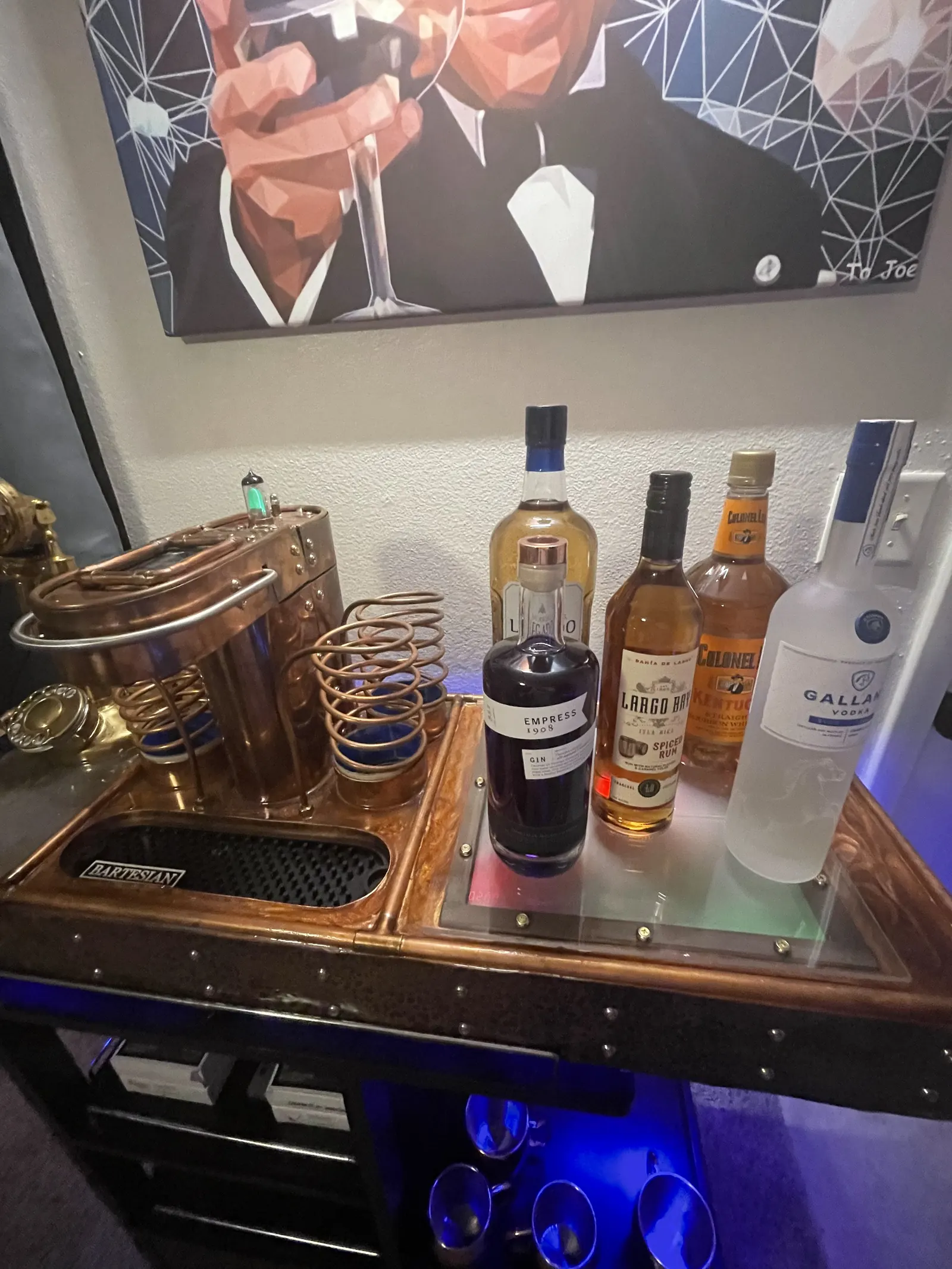 The finished machine on its cart with a stocked shelf of bottles