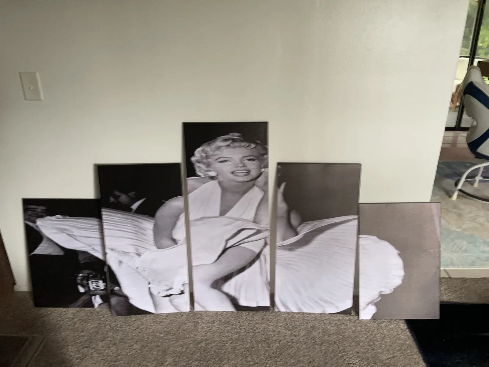 Five black-and-white Marilyn Monroe panels leaning against a wall, newly arrived