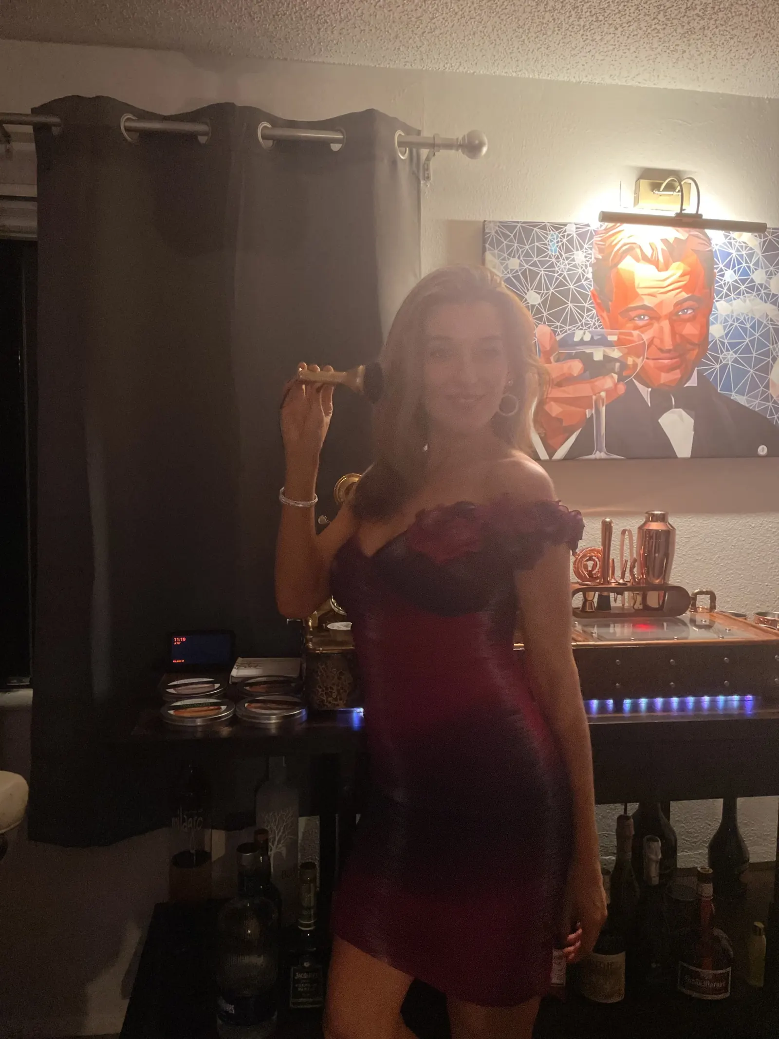 A guest in a red dress beside the machine