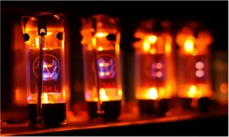 A bank of glowing electron tubes, orange and warm