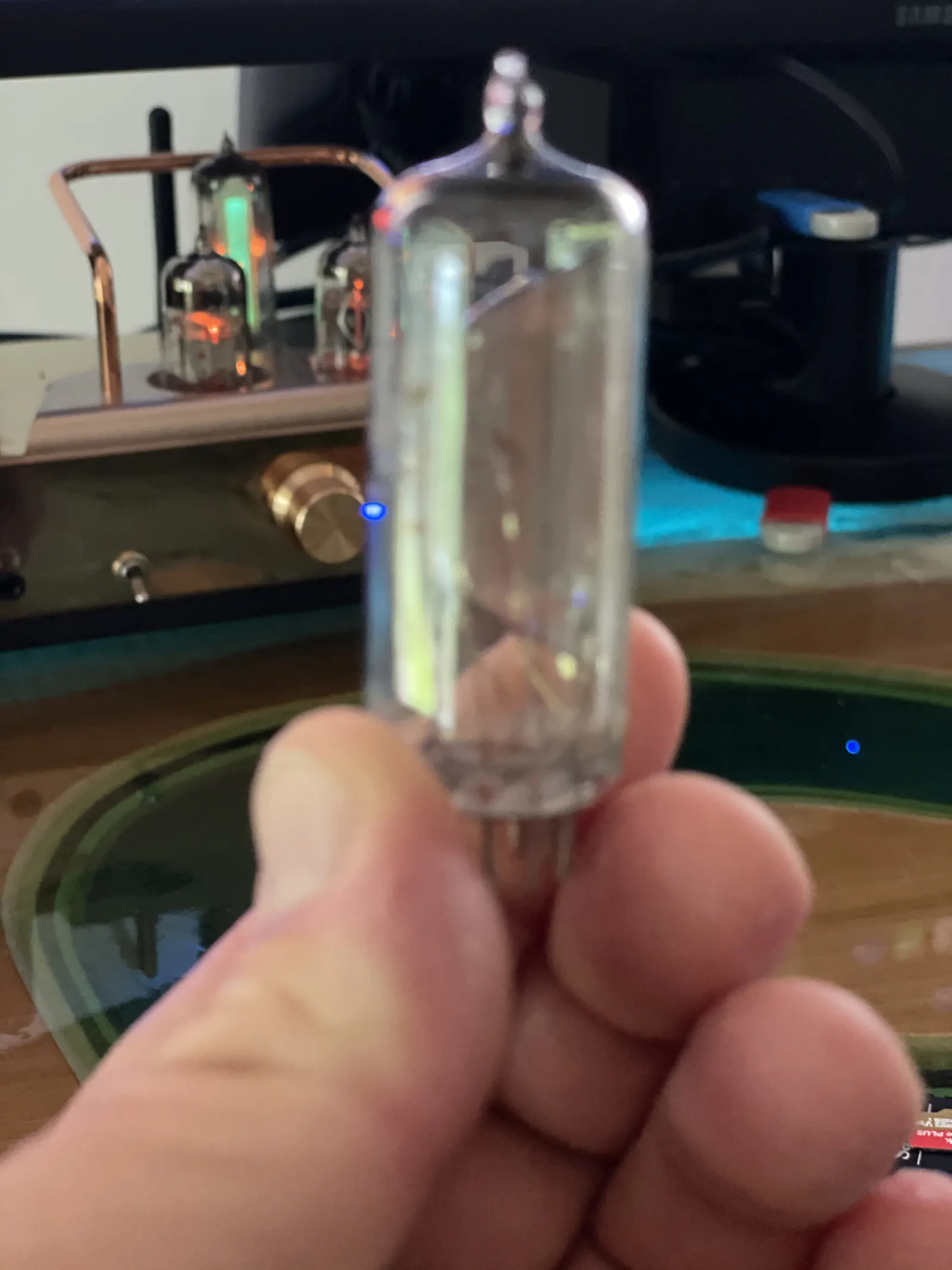 A Soviet 6E1N electron tube held up between fingers