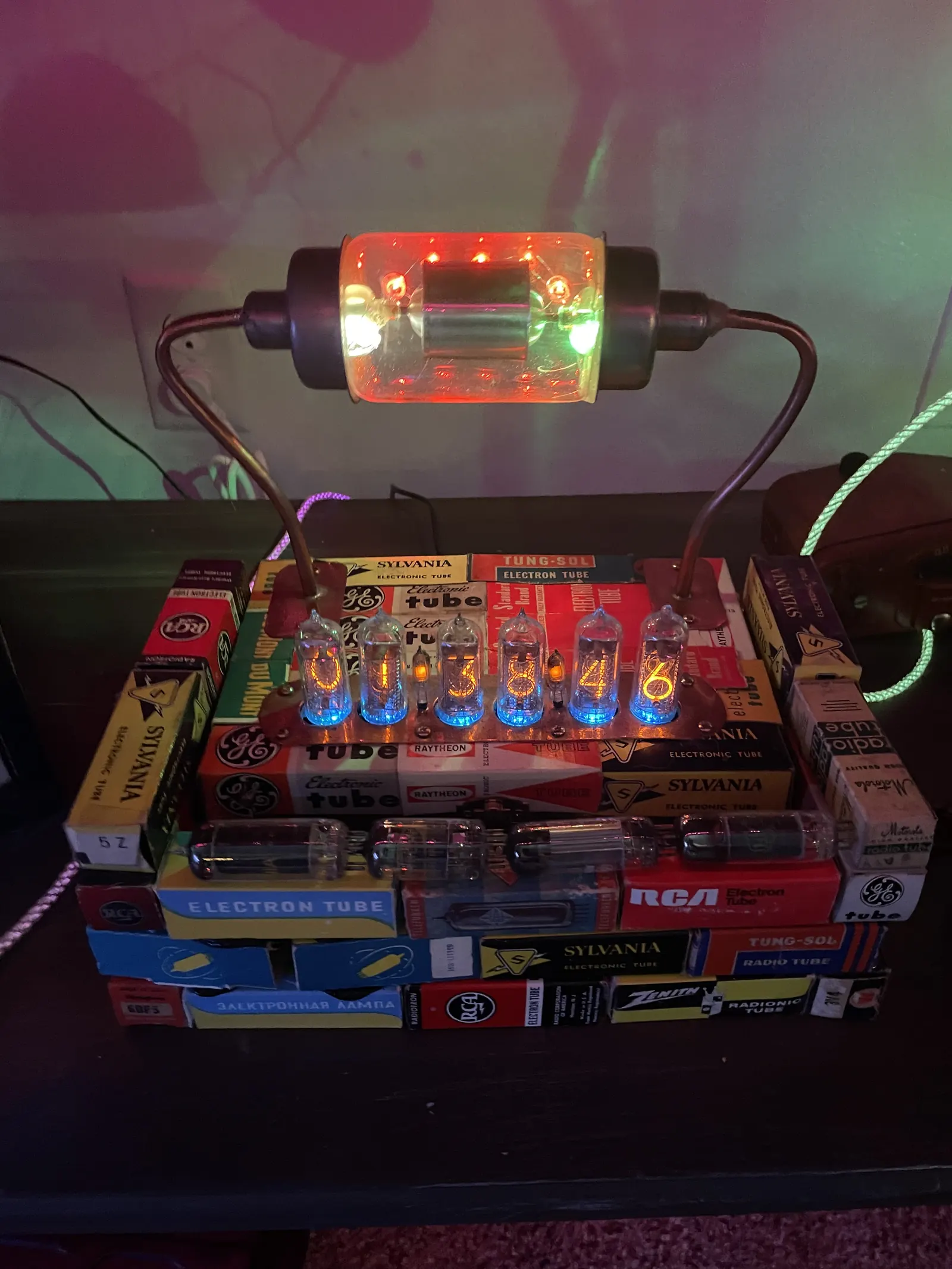 A large tube ringed with rainbow LEDs