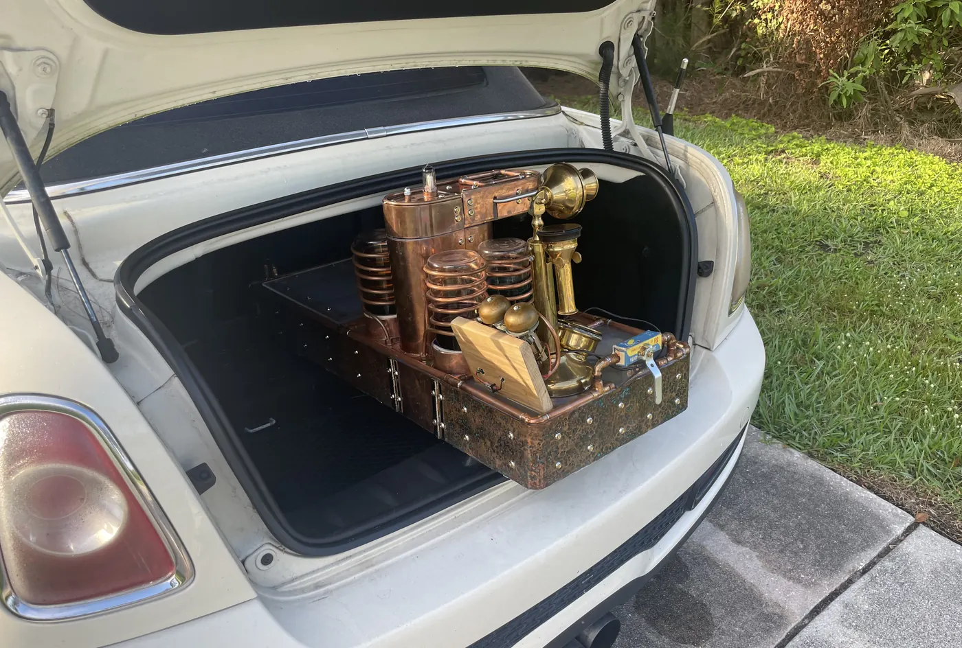 The machine sitting in the open trunk of a car